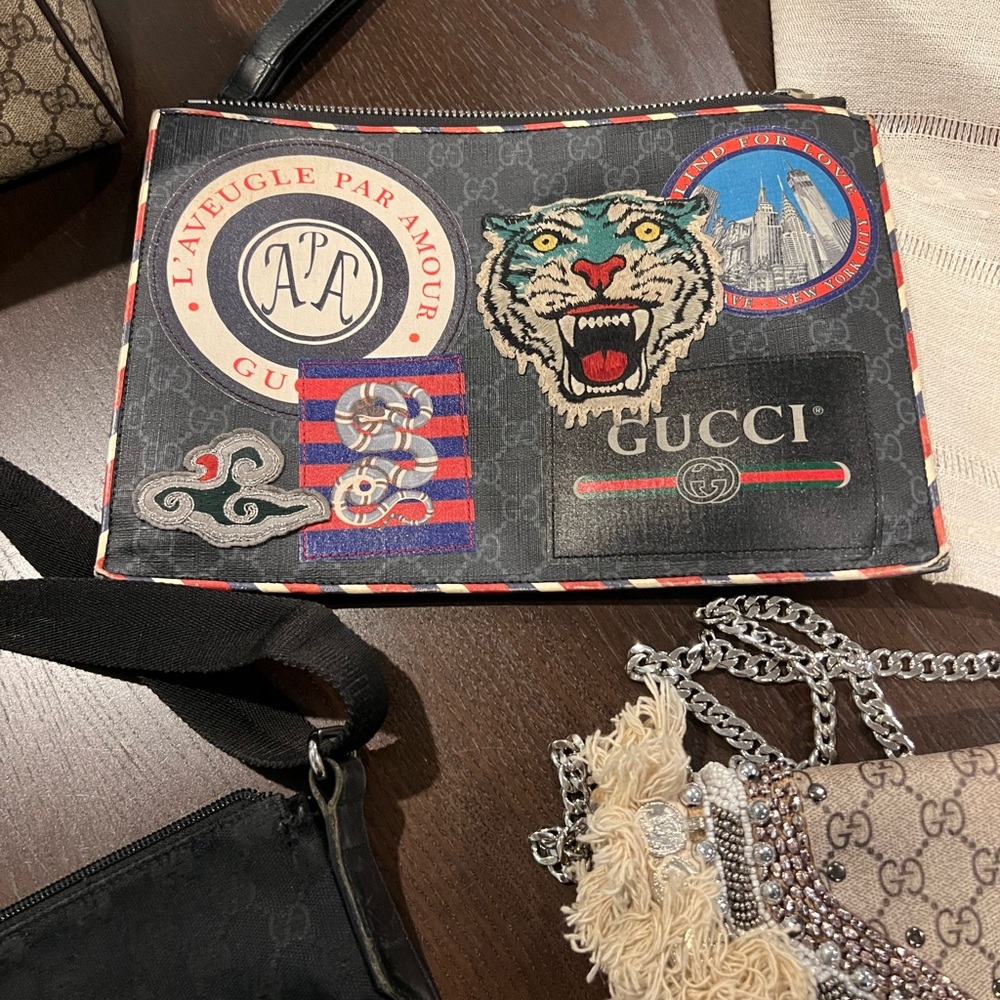 Used twice Gucci oversized clutch/with wrist strap. Patchwork - Picture 1 of 4